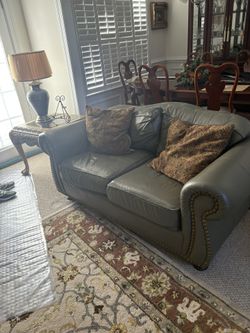 A leather sofa and a leather love seat. Two end tables and a coffee table and a sofa table. Pick up in Concord, NC