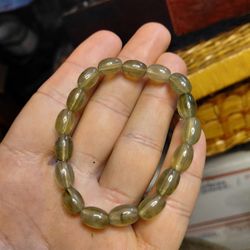 stretch bracelet made of polished, translucent, football-shaped glass or quartz beads. 