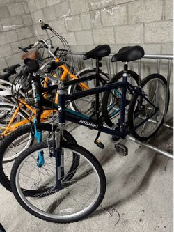 2 Nishiki Mountain Bikes + 2 Bell Helmets