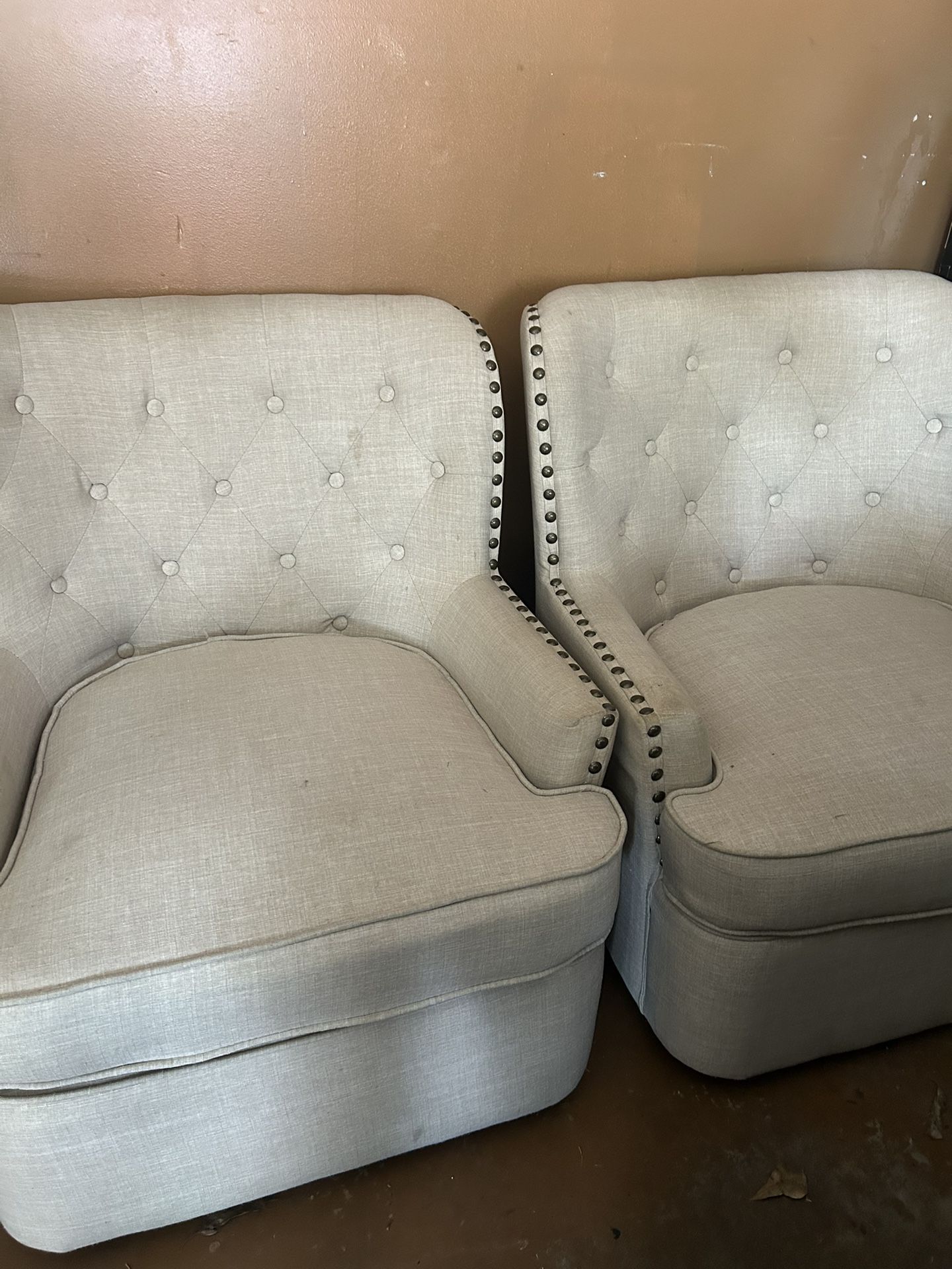 Two cream swivel chairs