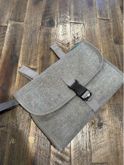 Diaper change pad with wipes compartment and stroller straps
