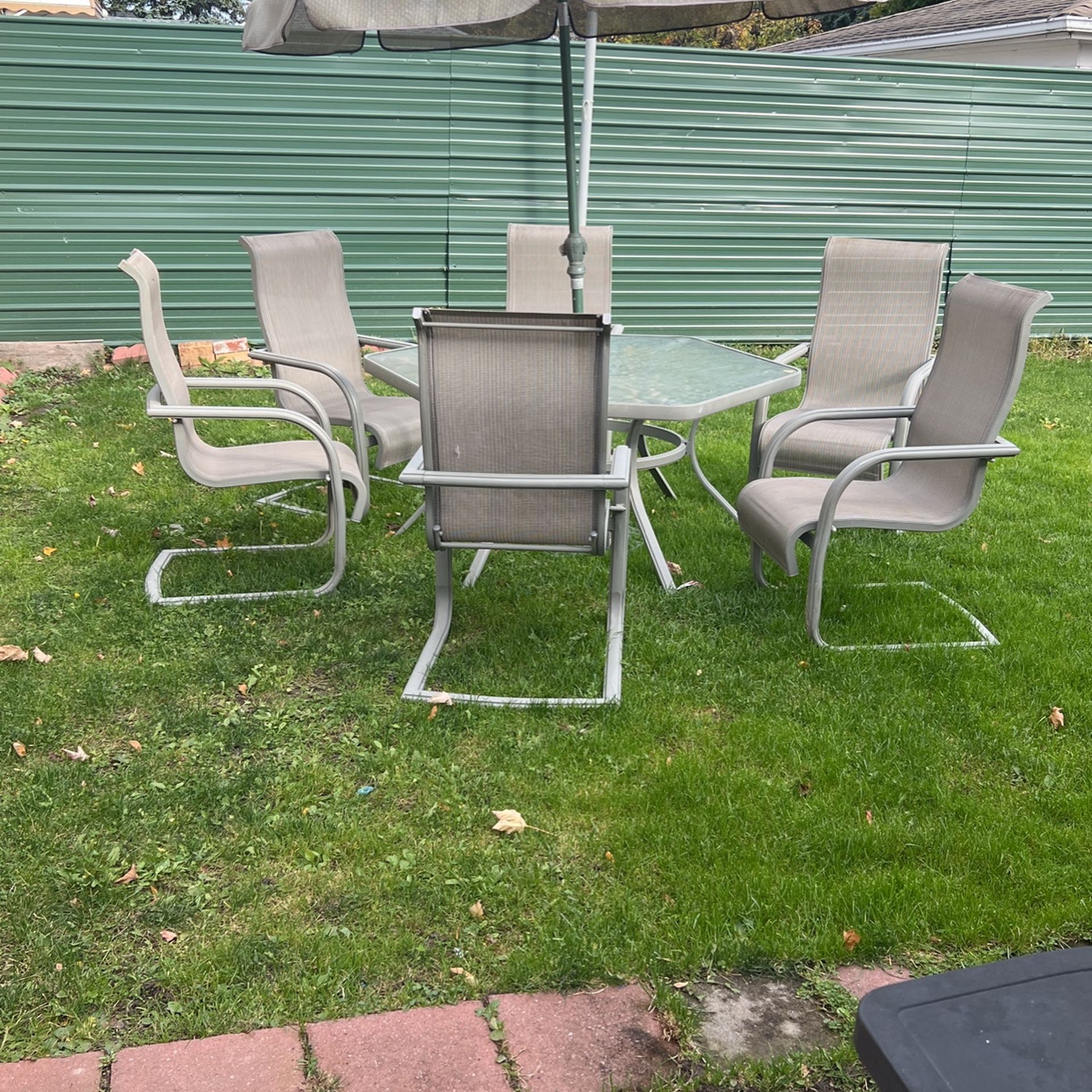 Outside Table With Umbrella And Six Chairs