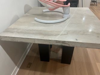 Mable table with four gray chairs