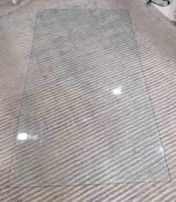 Rectangular glass table top suitable for dining or office use.