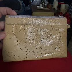 Coach patent leather perforated signature C wristlet. 