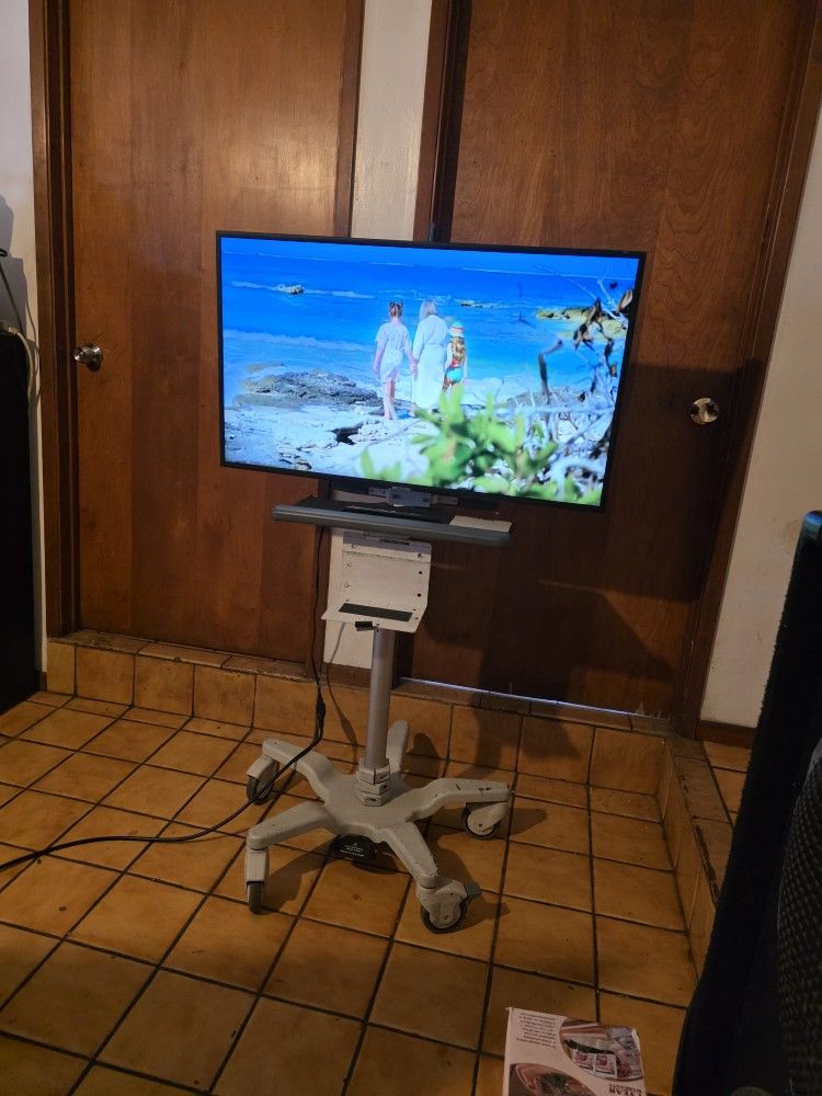 Samsung 40Inch. Smart TV With Rolling Stand Up Adjustable On Wheels Mobile Cart Desk