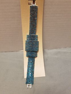 Sparkling bracelet with rows of teal crystals.