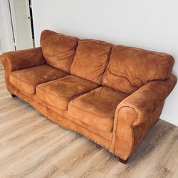 Overstuffed copper colored couch