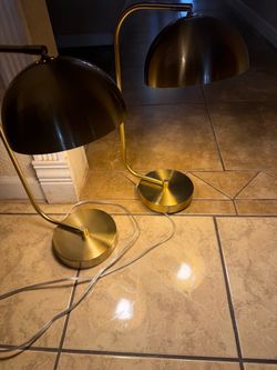 Two golden table lamps