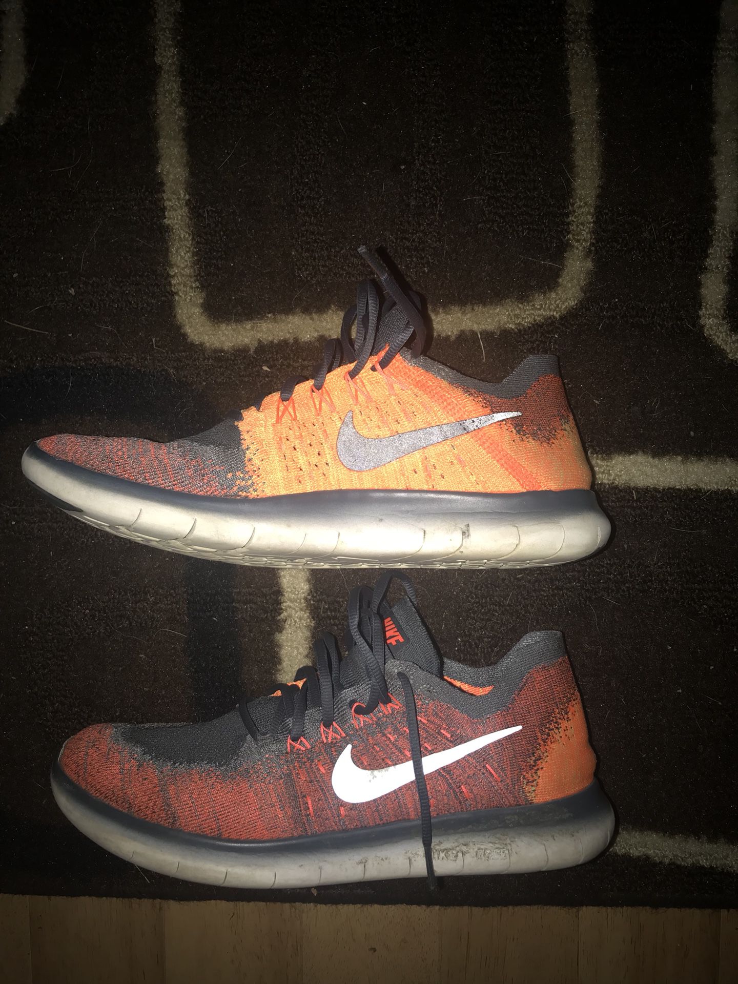 Orange and grey Nike running shoes.