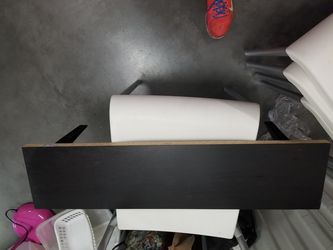 3 black shelves with shelf holders