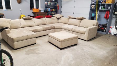 Tan Couch With Pillows And Foot Rest 