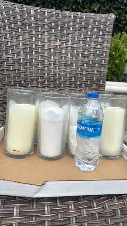 8 tall glass vases with candles inside