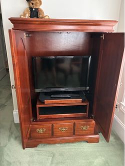 Wooden entertainment armoire with TV