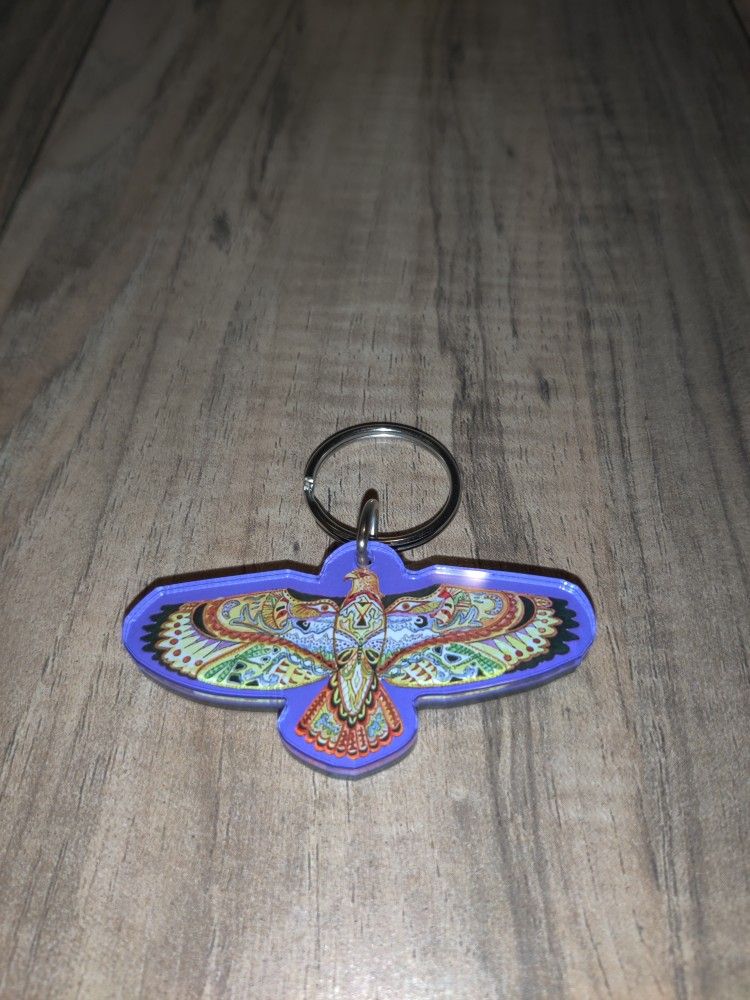 Sue Coccia Earth International Eagle Graphic Keychain. Has some wear from age and use. Sold as is.