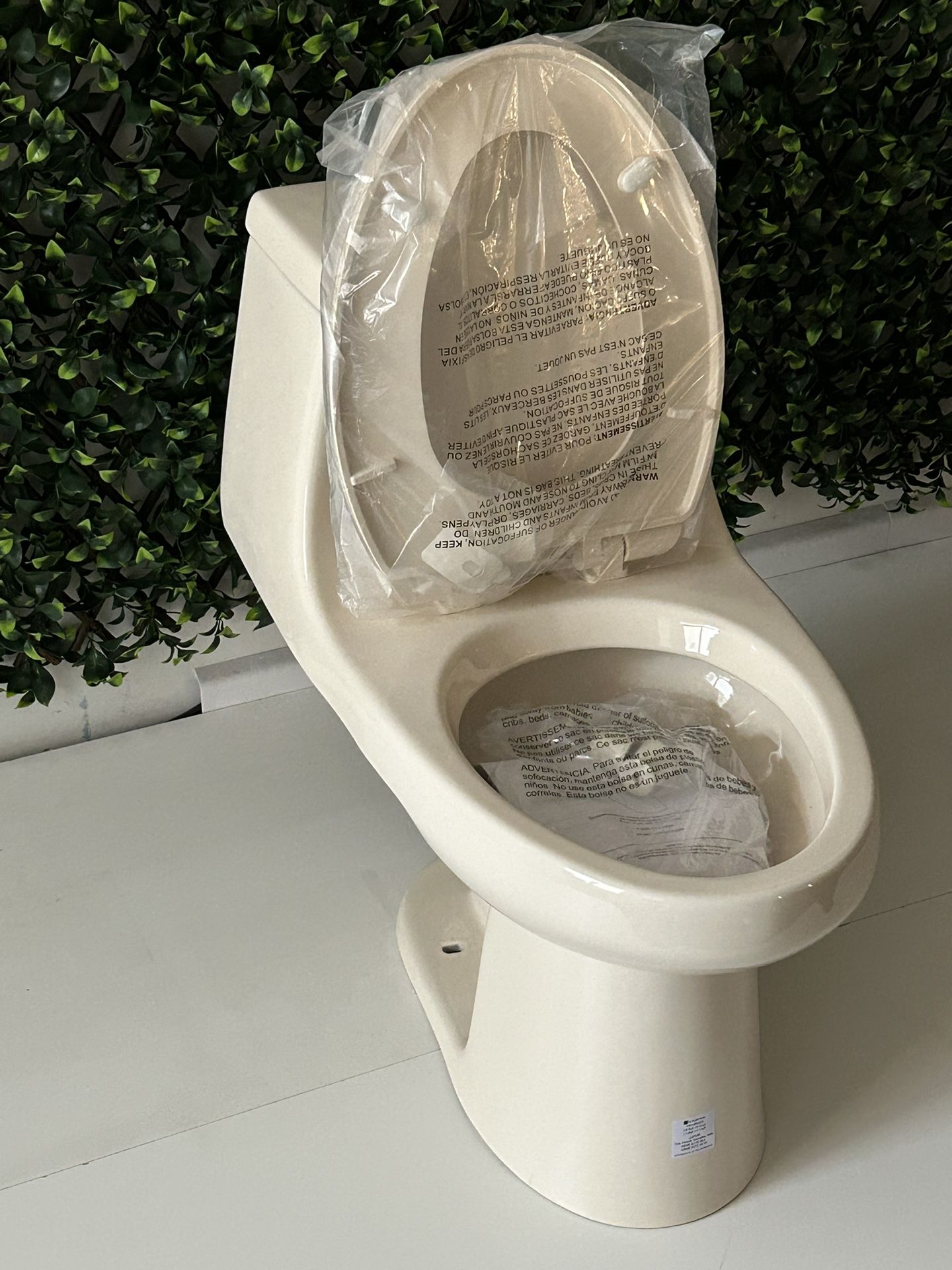 Glacier Bay McClure 1-piece 1.1 GPF/1.6 GPF High Efficiency Dual Flush Elongated Toilet in Bone, Seat Included