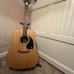 Acoustic Guitar (along with guitar Stand and Extra Strings)