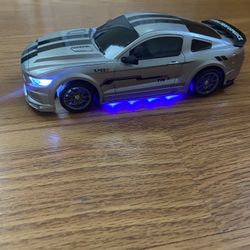 mustang race car with built in lights lithum  battery,  charger for battery , Extra tires , cones and a  remote control for $60