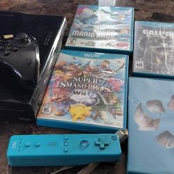 Nintendo Wii U console Black 32 GB, 1 controller, and several games