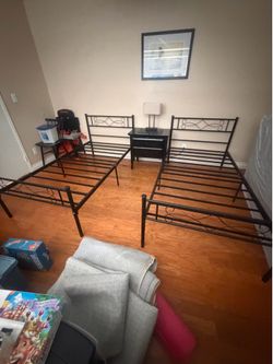 A set of 14 inch metal platform twin bed frames.