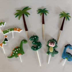 Dino cake decorations and “3” candle!