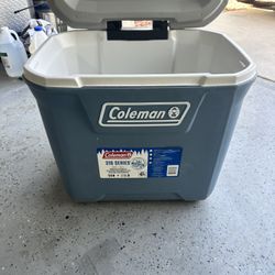 Coleman 316 Series Wheeled Cooler, specifically the 50 QT model in Blue Nights.  