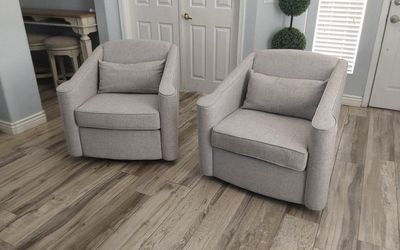 Two beautiful gray swivel accent chairs