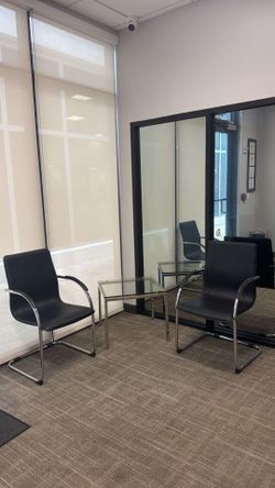 Two office chairs and glass table