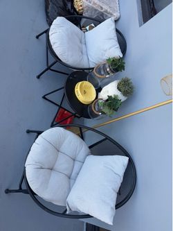 Two patio chairs, and a small table set