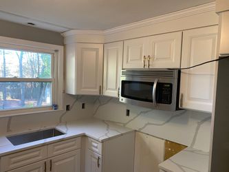 Kitchen Cabinets, Quartz Countertops, Vinyl Tiles.