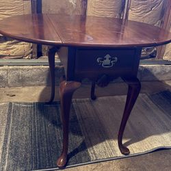  Cherry accent drop leaf wooded table with a drawer 