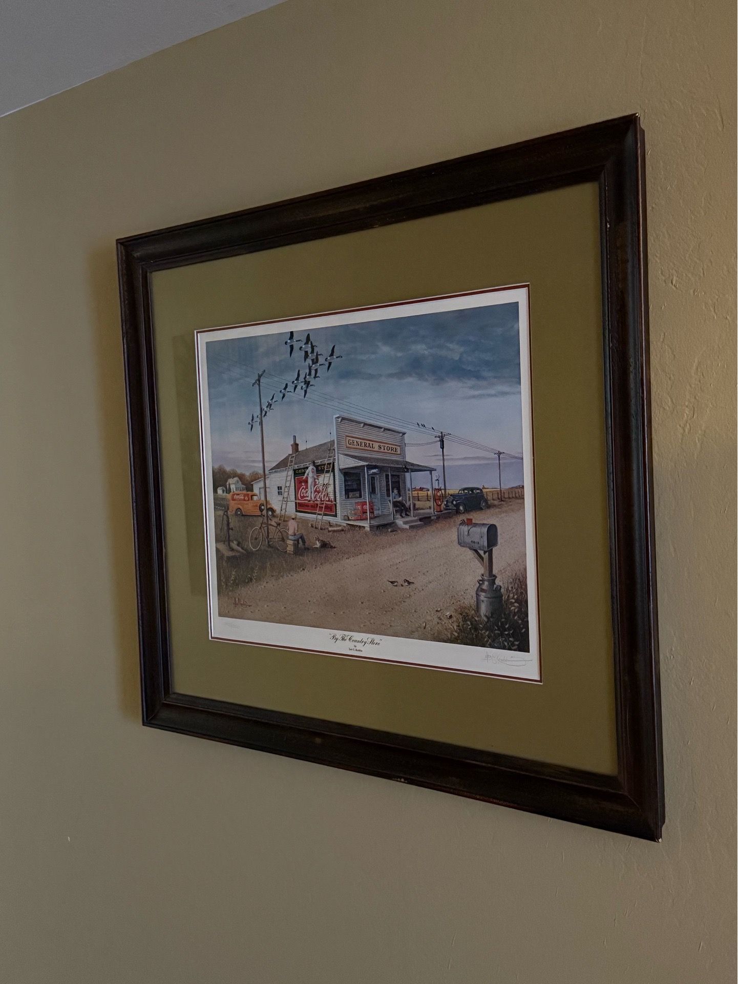 Les C. Kouba “By The Country Store" Framed Print