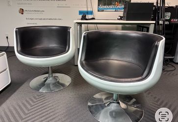 Black and white West Elm swivel chairs