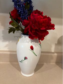 12” white vase with blue,red and yellow flowers on it