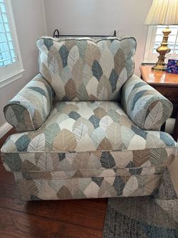 Lazy Boy Swivel Glider Recliner featuring a prominent leaf- patterned fabric la-Z