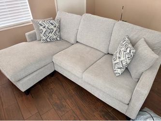 Gray three seat Sectional with reversible Chaise