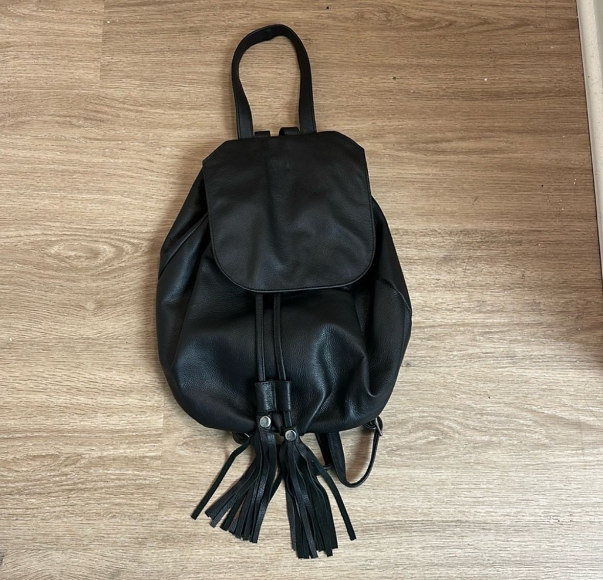 Black leather backpack with tassels