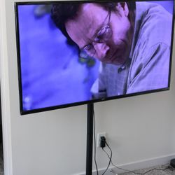 55" 4K UHD TV (Model: ONA55UB19E06) with TV stand.