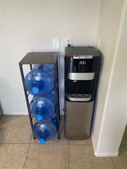 Water dispenser, 5 gallon jugs (4) and stand.