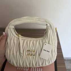 Mui Mui: A chic and versatile bag, perfect for adding a touch of understated elegance  to any outfit. 