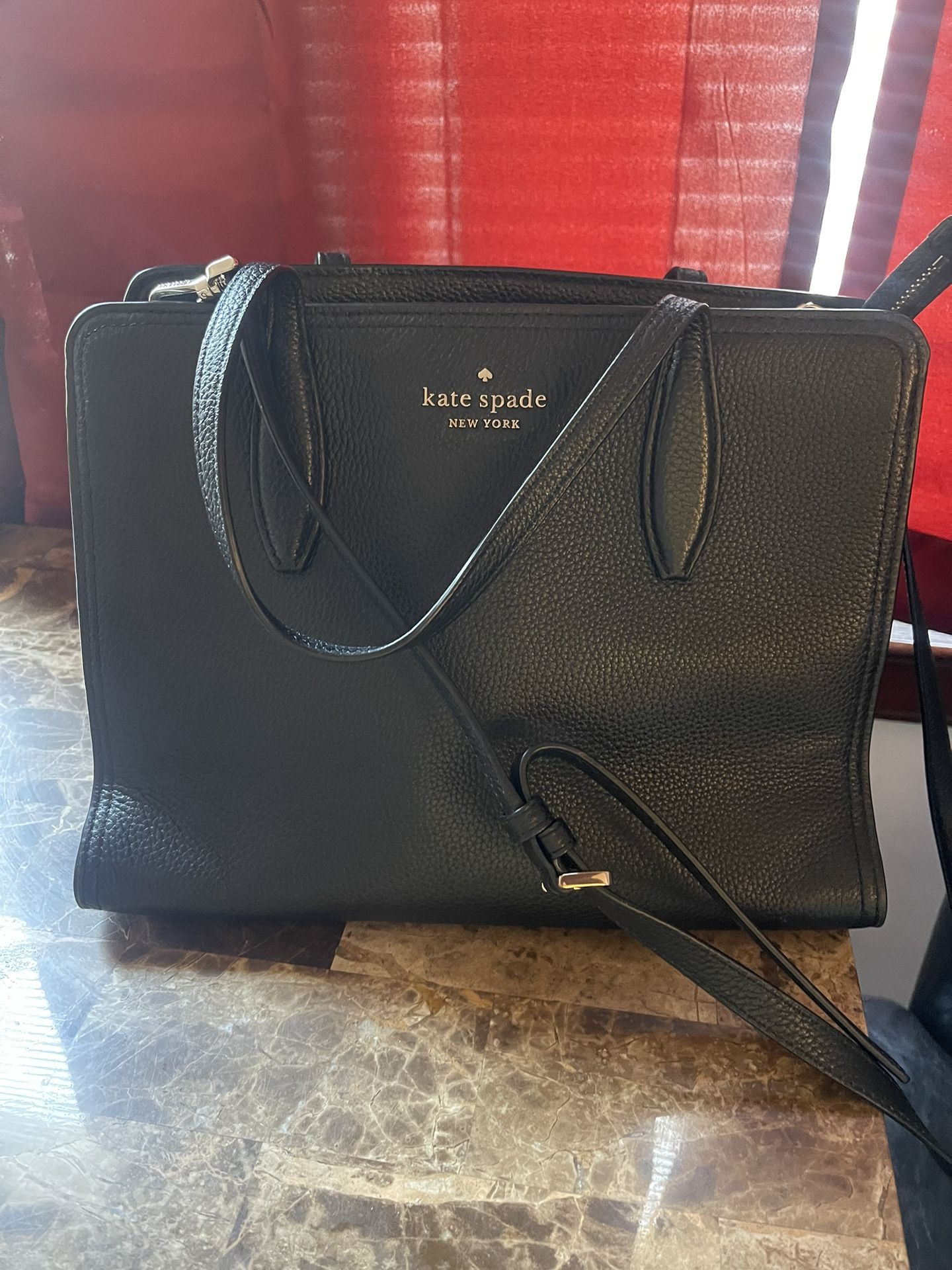 Kate Spade satchel purse with gold accents, handles/strap,