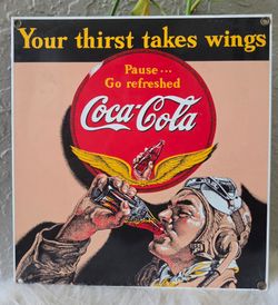 A vintage Coca-Cola Aviator Theme Sign