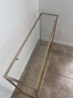 Glass console table with gold trim