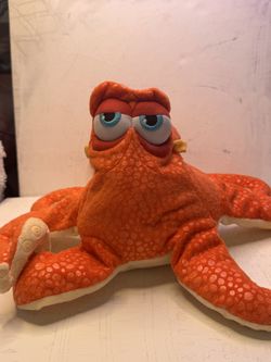 Character: Hank—a grumpy "septopus" (an octopus who has lost one tentacle). Material: Textured soft orange fabric featuring a distinctive pattern of s