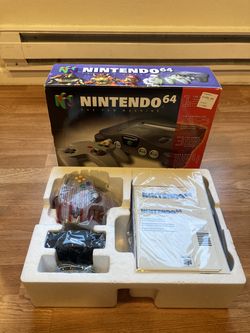 Nintendo 64 console complete in box with controller, wires, and paperwork