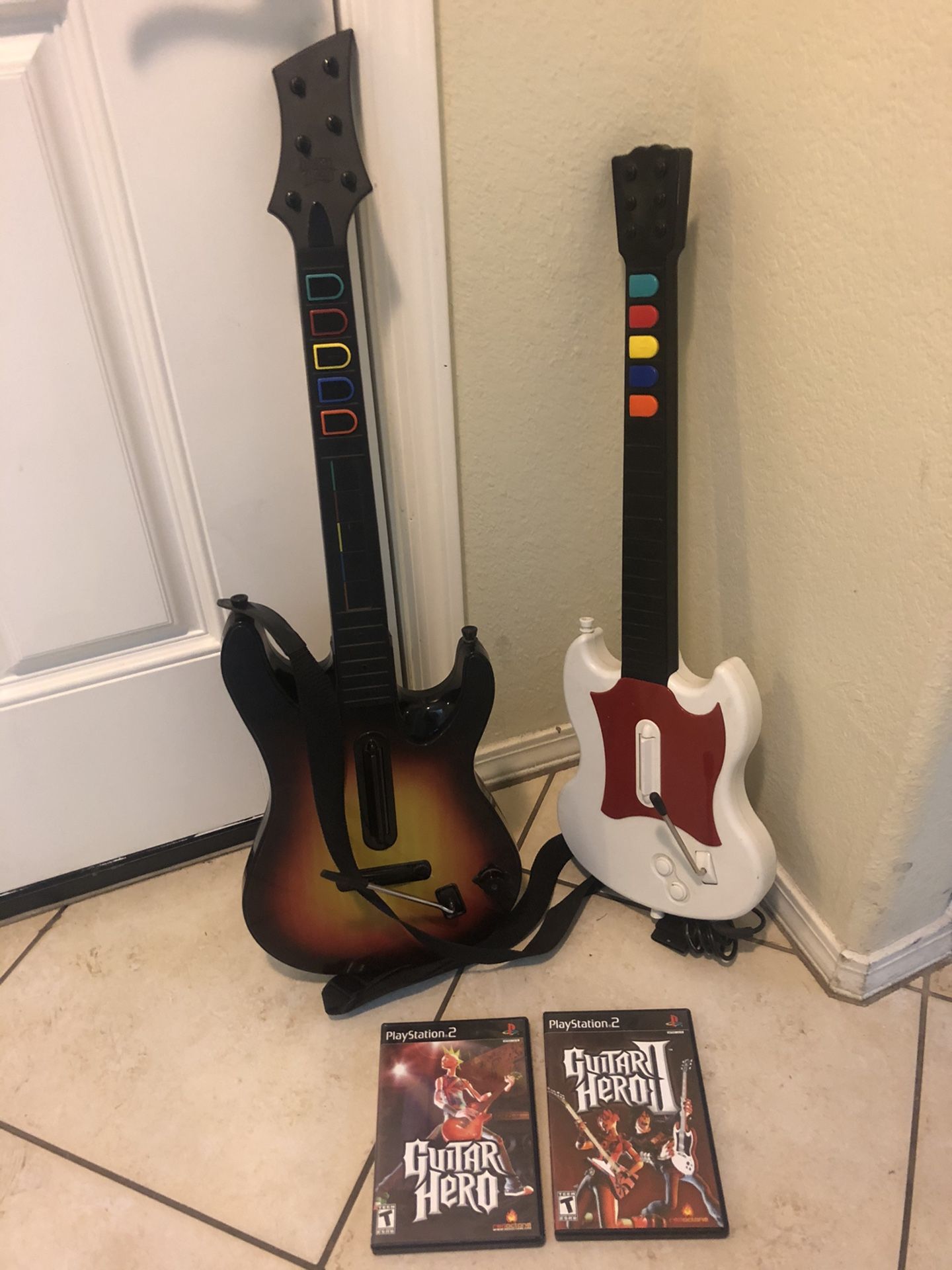 Playstation 2 PS2 2 Guitar Hero guitars & 2 games. All works well.