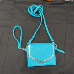 charming charlie turquoise/teal faux leather crossbody purse. Pebbled texture faux leather Teal/turquoise 3 pockets Magnetic front closure Inner