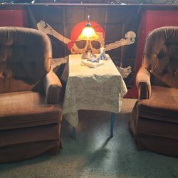 A pair of burnt orange rocking and swivel chairs