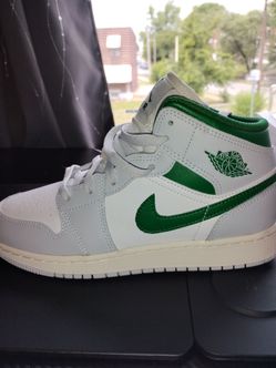 Nike Air Jordan 1 Mid sneakers in a Sumit White and Pine Green colorway,