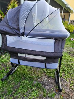 NEW Baby Boy Bassinet or Bedside Sleeper with mesh panels and a mosquito net